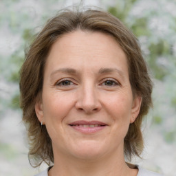 Joyful white adult female with medium  brown hair and brown eyes