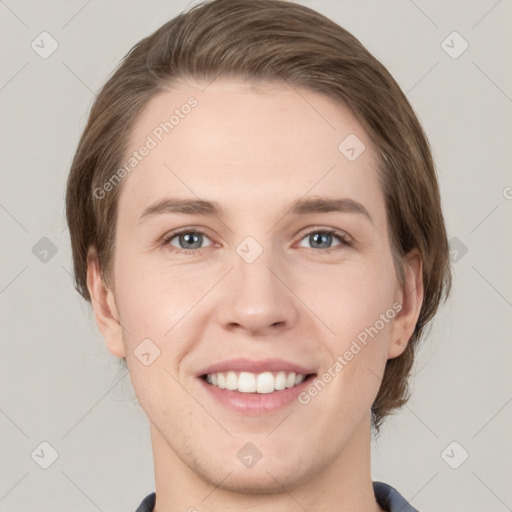 Joyful white young-adult female with medium  brown hair and grey eyes