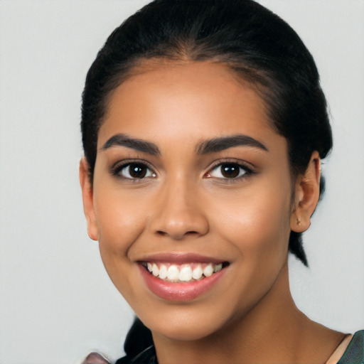 Joyful latino young-adult female with long  black hair and brown eyes