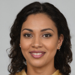 Joyful latino young-adult female with medium  brown hair and brown eyes