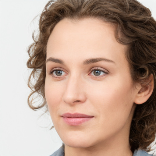 Joyful white young-adult female with medium  brown hair and green eyes