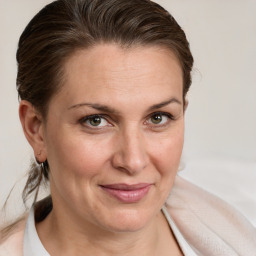 Joyful white adult female with medium  brown hair and brown eyes