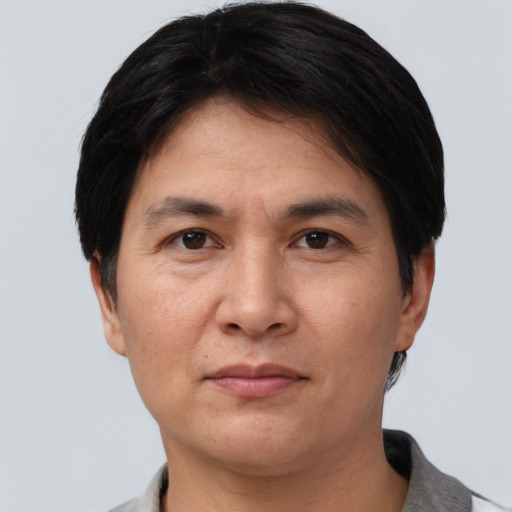 Joyful asian adult male with short  brown hair and brown eyes