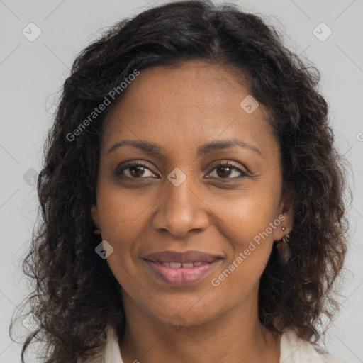 Joyful black young-adult female with long  brown hair and brown eyes