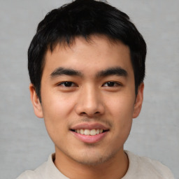 Joyful asian young-adult male with short  black hair and brown eyes