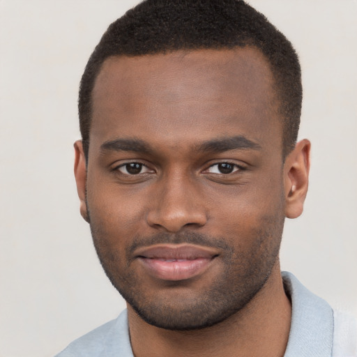 Joyful black young-adult male with short  brown hair and brown eyes