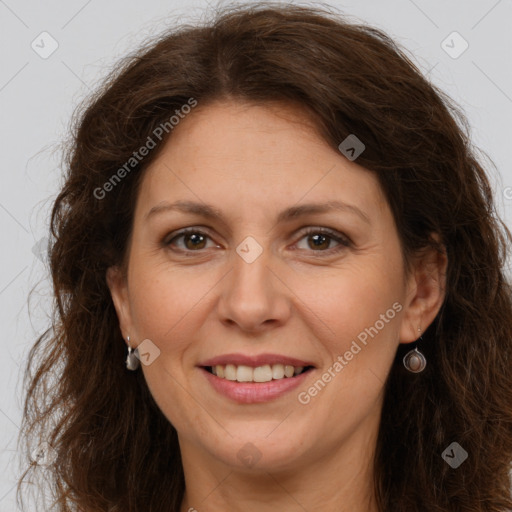 Joyful white adult female with long  brown hair and brown eyes