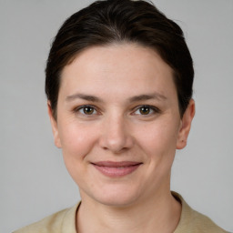 Joyful white young-adult female with short  brown hair and grey eyes