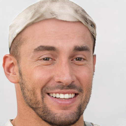 Joyful white adult male with short  brown hair and brown eyes