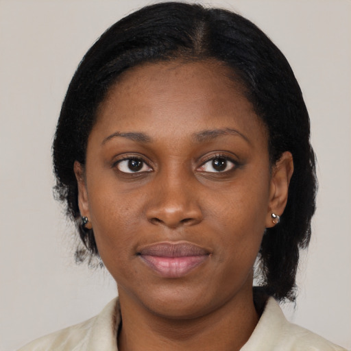 Joyful black young-adult female with medium  black hair and brown eyes