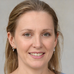 Joyful white adult female with medium  brown hair and grey eyes