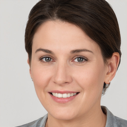 Joyful white young-adult female with medium  brown hair and brown eyes