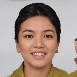 Joyful asian young-adult female with short  black hair and brown eyes