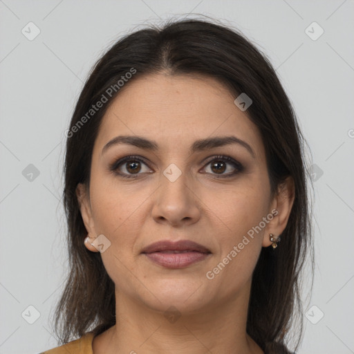 Joyful latino young-adult female with long  brown hair and brown eyes