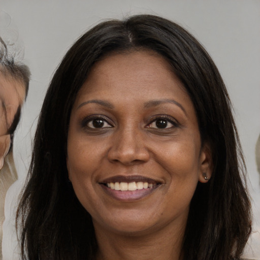 Joyful latino adult female with long  brown hair and brown eyes