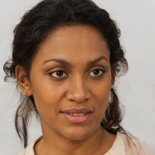 Joyful black young-adult female with medium  brown hair and brown eyes