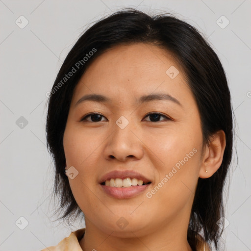 Joyful asian young-adult female with long  brown hair and brown eyes