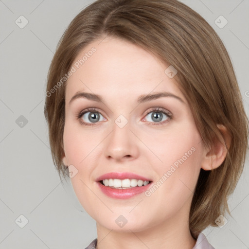 Joyful white young-adult female with medium  brown hair and blue eyes