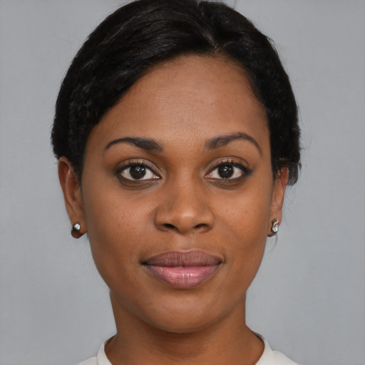 Joyful black young-adult female with short  brown hair and brown eyes