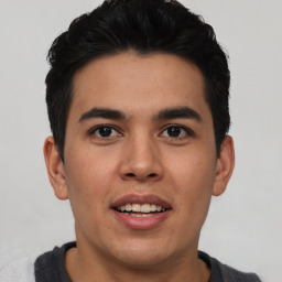 Joyful latino young-adult male with short  brown hair and brown eyes