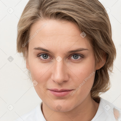 Joyful white young-adult female with medium  brown hair and grey eyes