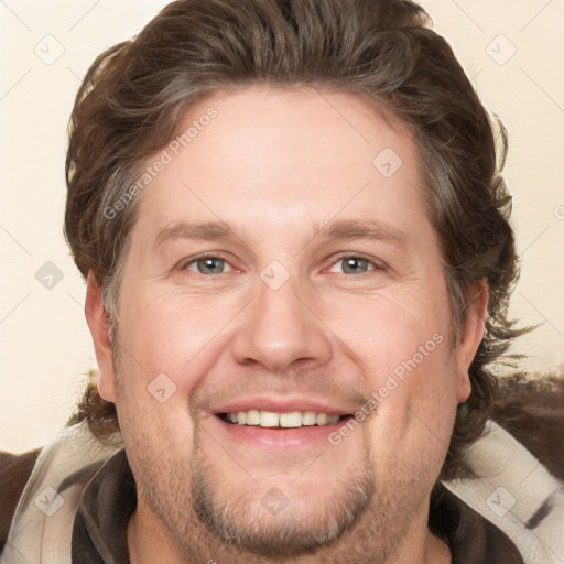 Joyful white adult male with short  brown hair and grey eyes