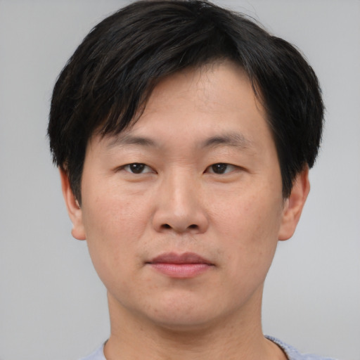 Neutral asian adult male with short  brown hair and brown eyes