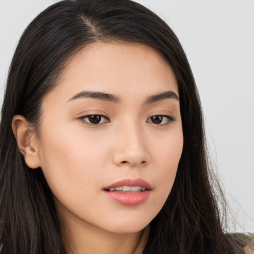 Joyful asian young-adult female with long  brown hair and brown eyes