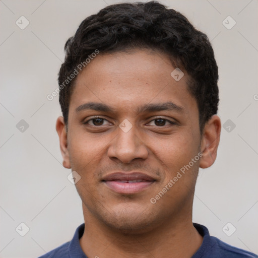 Joyful latino young-adult male with short  brown hair and brown eyes