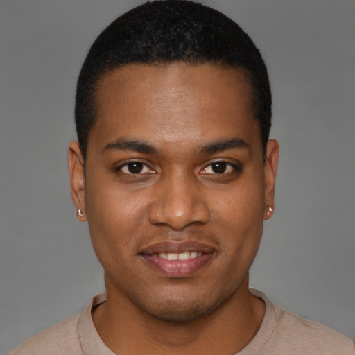 Joyful black young-adult male with short  brown hair and brown eyes