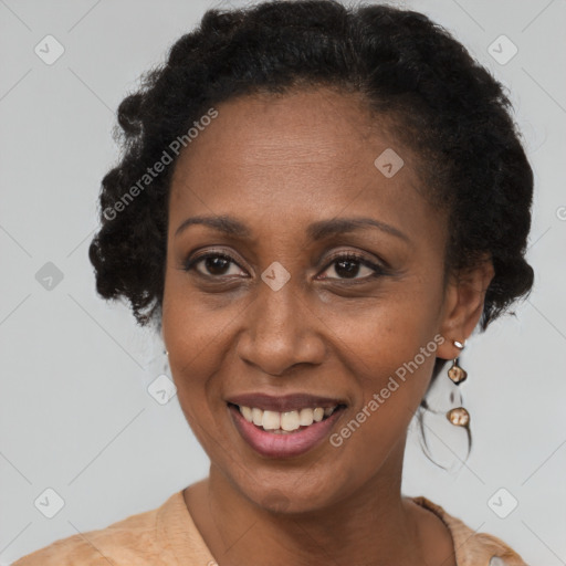 Joyful black adult female with short  brown hair and brown eyes