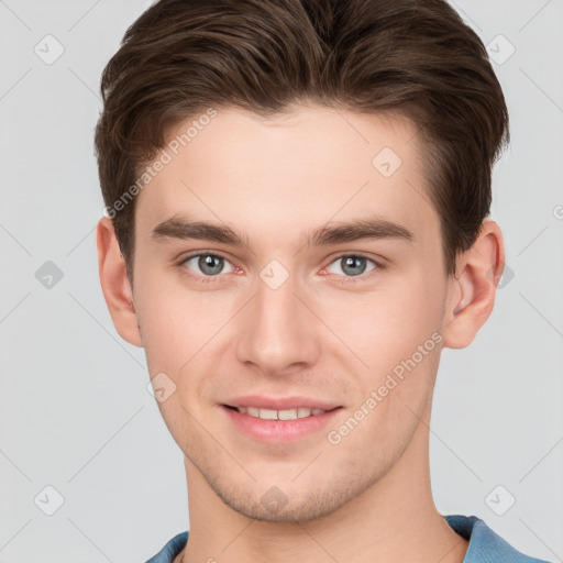 Joyful white young-adult male with short  brown hair and grey eyes