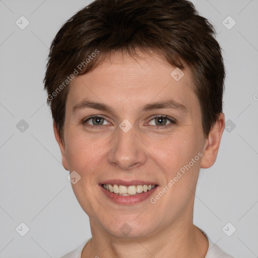 Joyful white young-adult female with short  brown hair and grey eyes