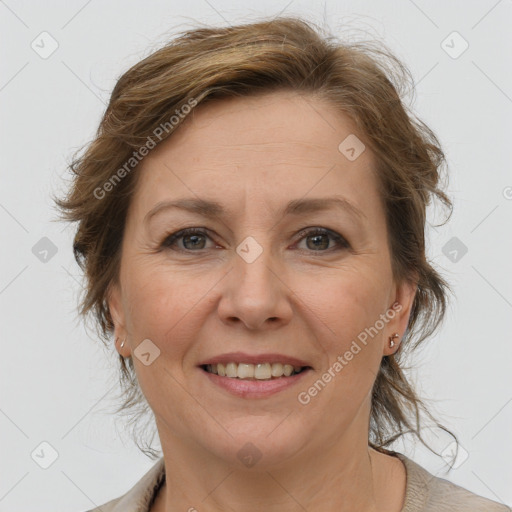 Joyful white adult female with medium  brown hair and grey eyes