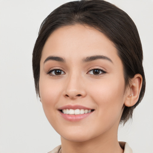 Joyful white young-adult female with medium  brown hair and brown eyes