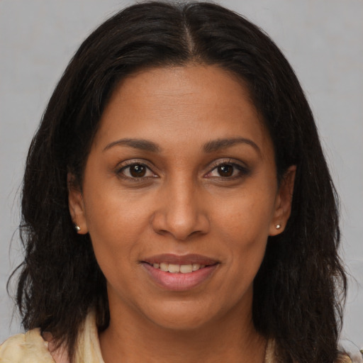 Joyful black adult female with medium  brown hair and brown eyes