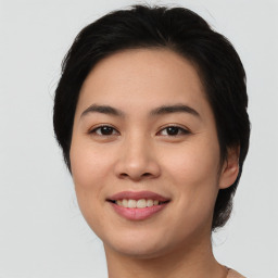 Joyful asian young-adult female with medium  black hair and brown eyes