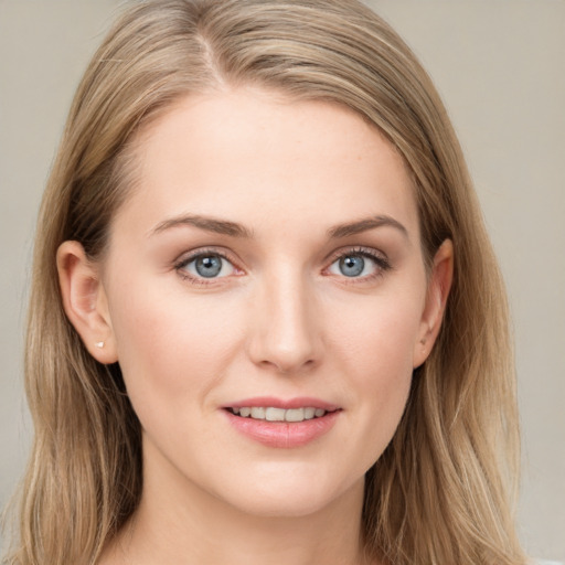 Joyful white young-adult female with long  brown hair and blue eyes