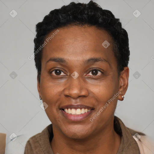 Joyful black adult female with short  brown hair and brown eyes