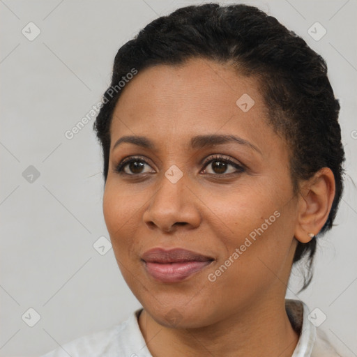 Joyful black adult female with short  brown hair and brown eyes