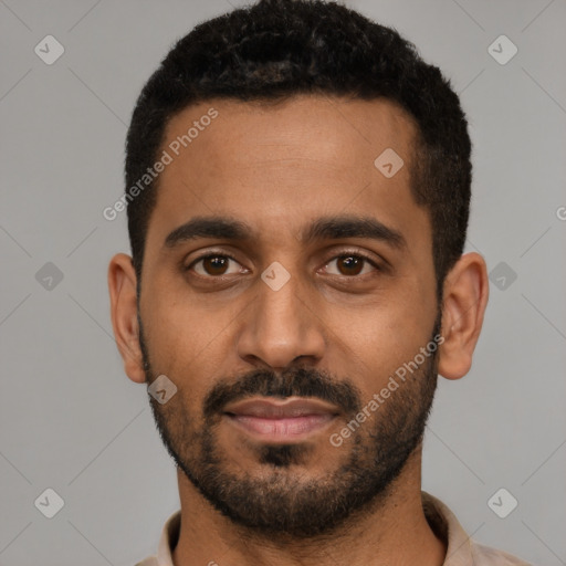 Joyful black young-adult male with short  black hair and brown eyes