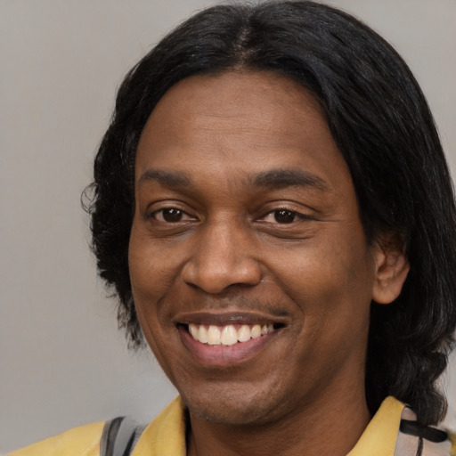 Joyful latino adult male with medium  brown hair and brown eyes