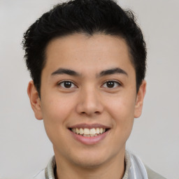 Joyful latino young-adult male with short  brown hair and brown eyes