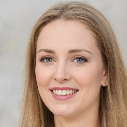 Joyful white young-adult female with long  brown hair and green eyes