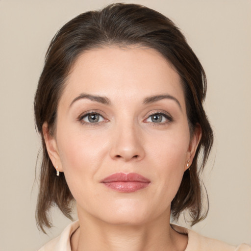 Joyful white young-adult female with medium  brown hair and brown eyes