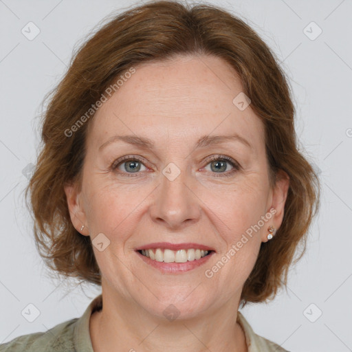 Joyful white adult female with medium  brown hair and grey eyes