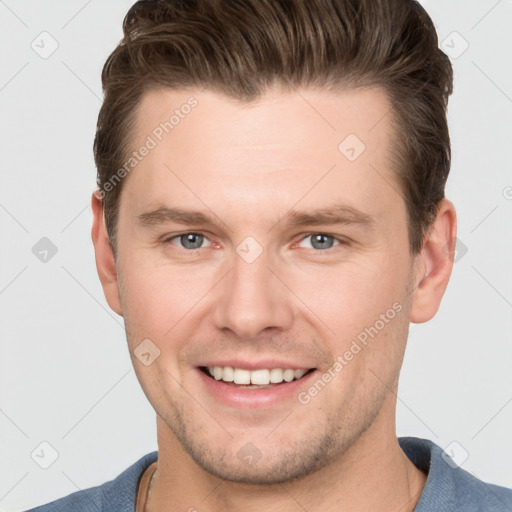 Joyful white young-adult male with short  brown hair and grey eyes