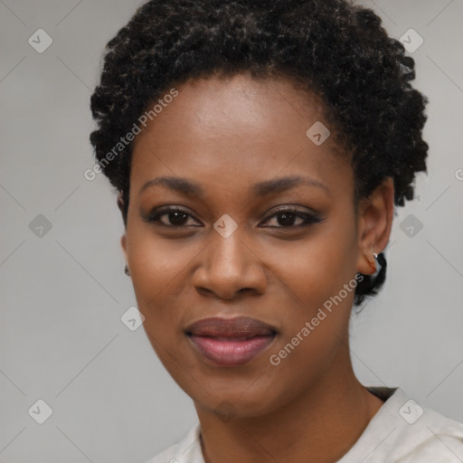 Joyful black young-adult female with short  black hair and brown eyes