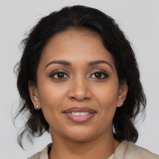 Joyful black young-adult female with medium  brown hair and brown eyes