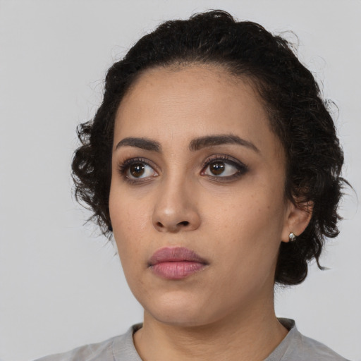 Neutral latino young-adult female with long  black hair and brown eyes